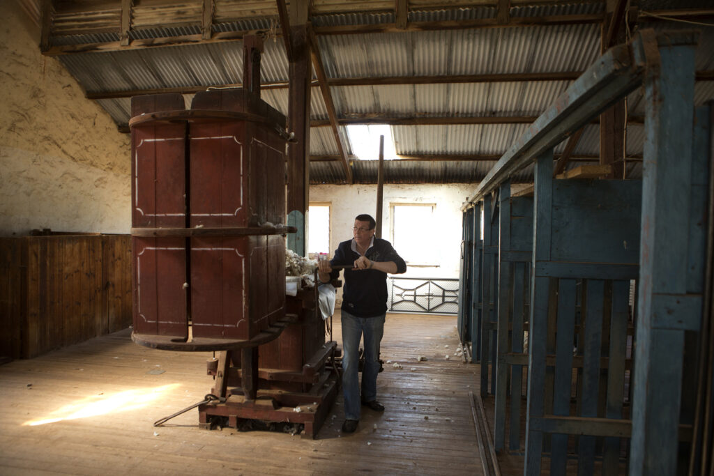 Figure 9: Andrew Morphett using the Koertsz wool press inside the woolshed. Source: Anlaby.